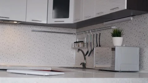A freelancer man starts his work day from home, sits at a table and opens a Stock Footage 127607489