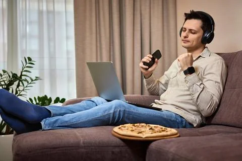 Freelancer man using smart phone and laptop Stock Photos
