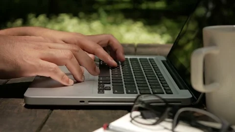 Freelancer man working on computer laptop in the park Stock Footage 70556469