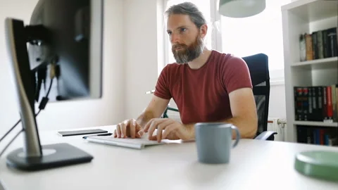 Freelancer man working from his home office desk Stock Footage 130173873