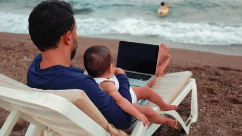 Freelancer man working on laptop and looking after children. Remote work concept Stock Footage 204860401