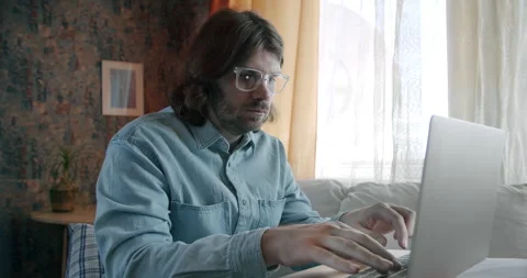 Freelancer man working with laptop. Work at home. Content writer, developer Stock Footage 245804079