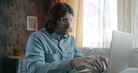 Freelancer man working with laptop. Work at home. Typing data entry, programmer Stock Footage 245806410