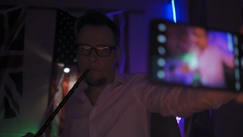 Freelancer in neon light making selfie Video stock 130059064