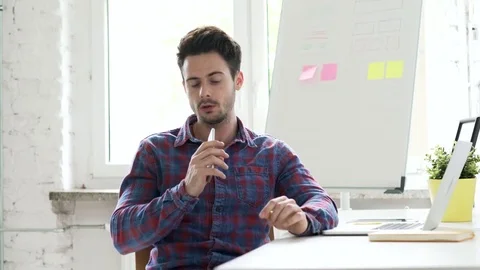 Freelancer at office talking on the phone Stock Footage 75933094