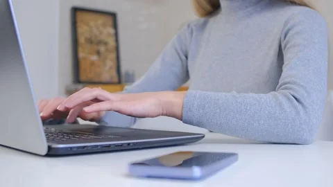 Freelancer person working on a notebook pc at home, focus on hands typing text Stock Footage 242479658