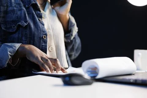 Freelancer on phone and checking papers 스톡 사진