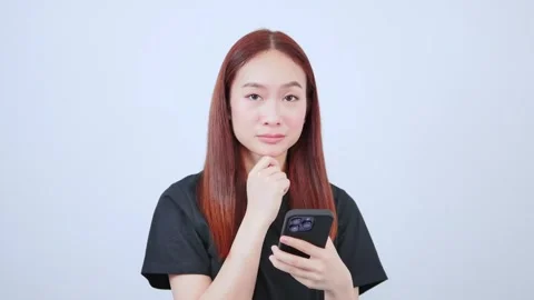 Freelancer playing mobile phone looking at smartphone standing Stock Footage 240724403