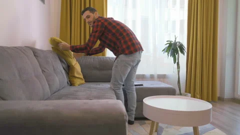 Freelancer prepares his workplace on a comfortable sofa at home Video stock 141926515