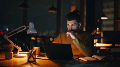 Freelancer programming laptop late evening in coworking office serious closeup. Stock Footage 340168451