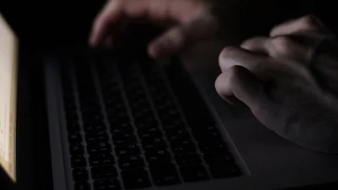 Freelancer programming at night on laptop with blurry screen close-up Stock Footage 121582190