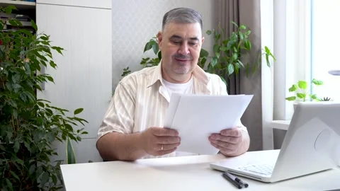 Freelancer Reviewing Financial Documents. Remote Work Concept. Stock Footage 276100032