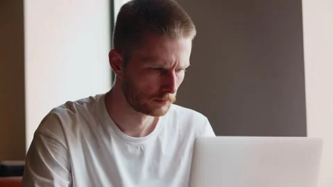 Freelancer sits in a cafe with a cup of coffee and works on a laptop. A Stock Footage 237031849