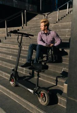 Freelancer sits on the steps to work. The concept of a designated meeting in a Stock Photos