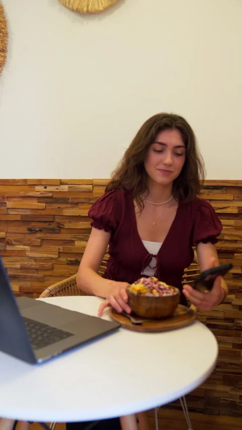 Freelancer taking a selfie while eating an acai bowl in a cafe. Stock Footage 310346080