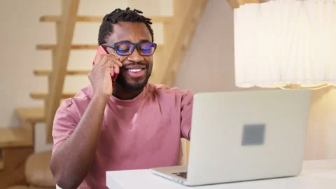 Freelancer talking by mobile phone when working with laptop at home, portrait of Stock Footage 262689048