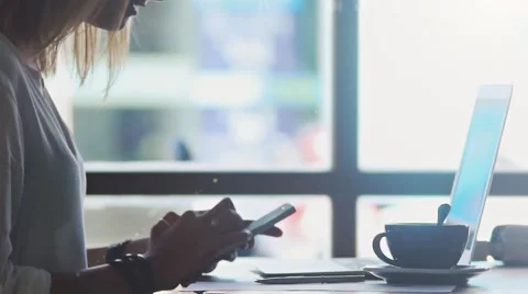 Freelancer texting in mobile phone in cafe Stock Footage