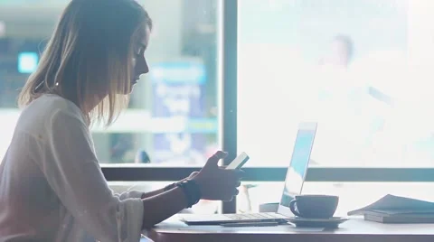Freelancer texting in mobile phone in cafe Stock Footage 64420359