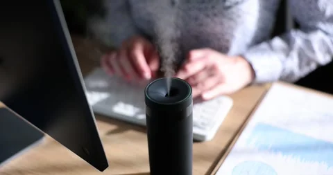Freelancer types article on keyboard inhaling scent of oils Stock Footage 278971990