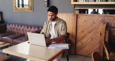 Freelancer, typing and man with laptop in coffee shop for remote work, document Stock Footage 329819260