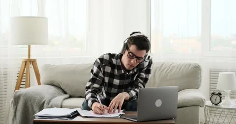 Freelancer Typing on Laptop and Taking Notes in Documents Video stock 250030957