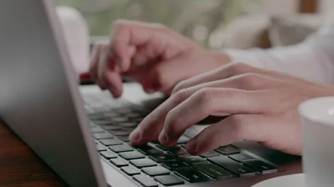Freelancer typing on a laptop in a cafe Stock Footage 159898943
