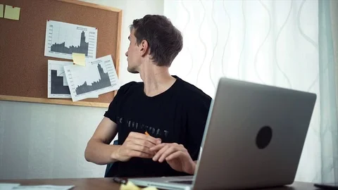 Freelancer typing at laptop computer working with analyze graphs in home office Stock Footage 79899245