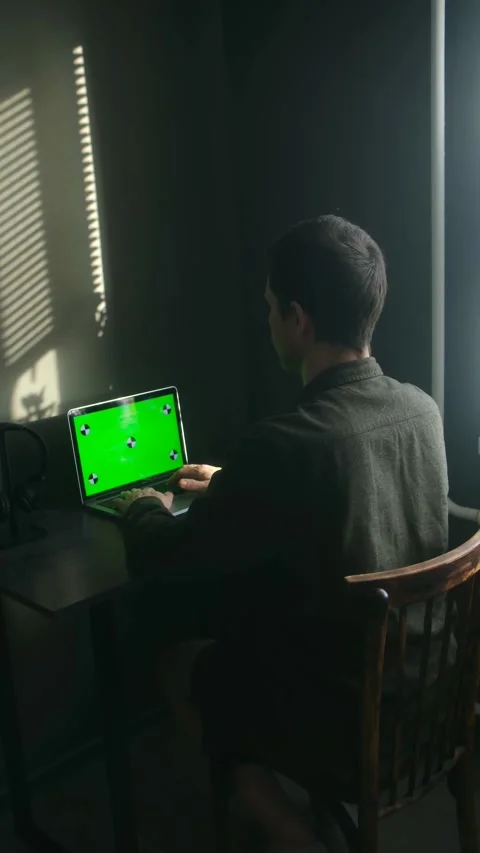 Freelancer typing on laptop with green screen at home office desk Stock Footage 337827337
