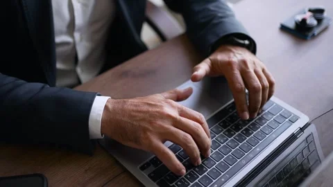 A freelancer typing on a laptop keyboard in a cafe. A businessman working in an Stock Footage 253775260
