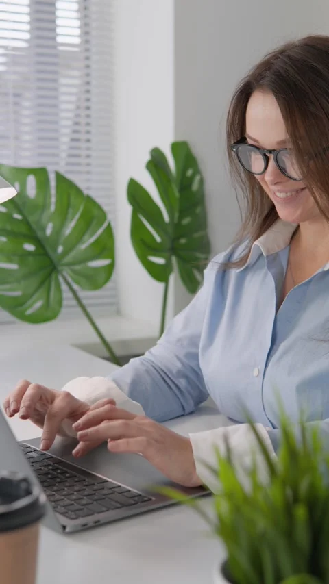 The freelancer uses her laptop to work from anywhere, which allows her to be Stock Footage 265983951