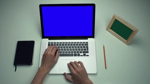 Freelancer using laptop computer with green screen at white desk Stock Footage 82893269