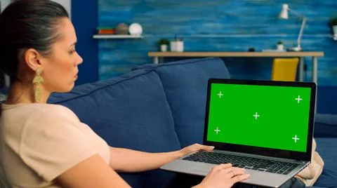 Freelancer using laptop computer with mock up green screen Stock Photos