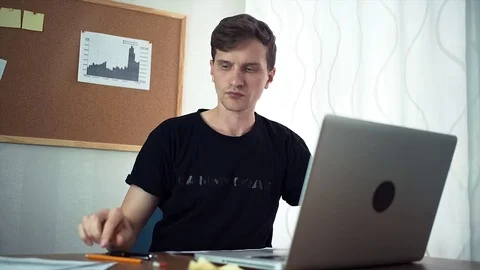Freelancer using laptop computer working with analyze graphs in the home office Stock Footage 79899549
