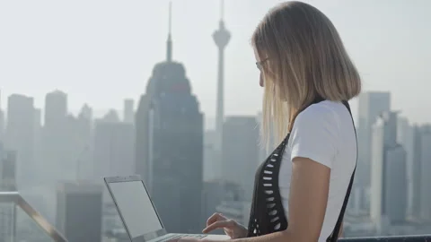 Freelancer using laptop on modern city background. Stock Footage 85979323