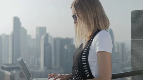 Freelancer using laptop on modern city background. Stock Footage 85979569