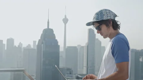 Freelancer using laptop on modern city background. Stock Footage 85979849