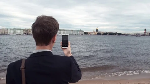 Freelancer using laptop sitting on bench near seafront. Summer day Stock Footage 80008970