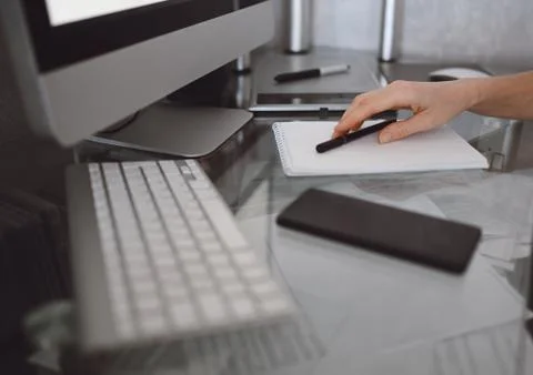 Freelancer using smart phone and laptop at home during quarantine. Stock Photos