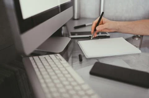 Freelancer using smart phone and laptop at home during quarantine. Stock Photos