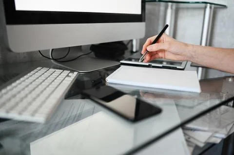 Freelancer using smart phone and laptop at home during quarantine. Stock Photos