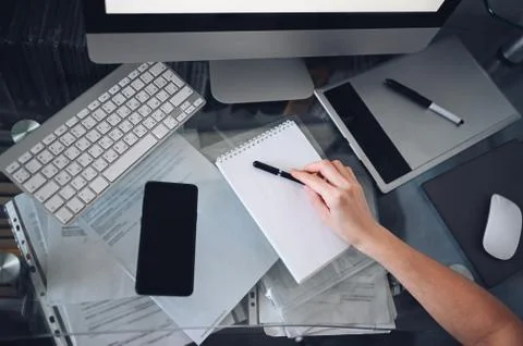 Freelancer using smart phone and laptop at home during quarantine. Stock Photos