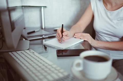 Freelancer using smart phone and laptop at home during quarantine. Stock Photos