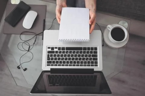 Freelancer using smart phone and laptop at home during quarantine. Stock Photos