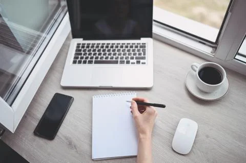 Freelancer using smart phone and laptop at home during quarantine. Foto stock