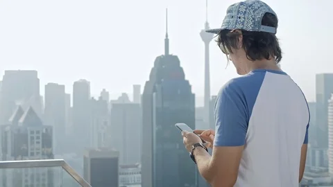 Freelancer using smartphone on modern city background. Stock-Footage 86219715