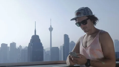 Freelancer using smartphone on modern city background. Stock Footage 106620399