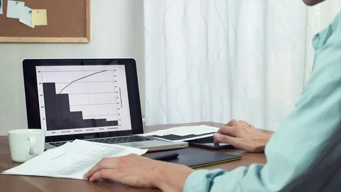 Freelancer using tablet and laptop computer working with analyze graphs Stock-Footage 81879753