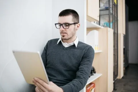 Freelancer using tablet while sitting in office Stock Photos