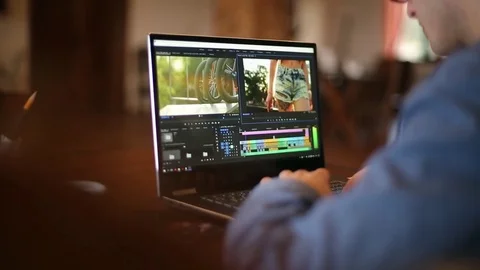 Freelancer video editor works at the laptop computer with movie editing sofware Stock Footage