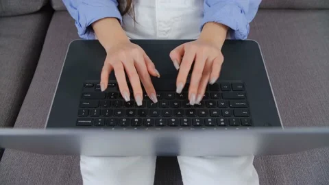 Freelancer woman types text on notebook computer at home in 4k video clip Stock Footage 208767375